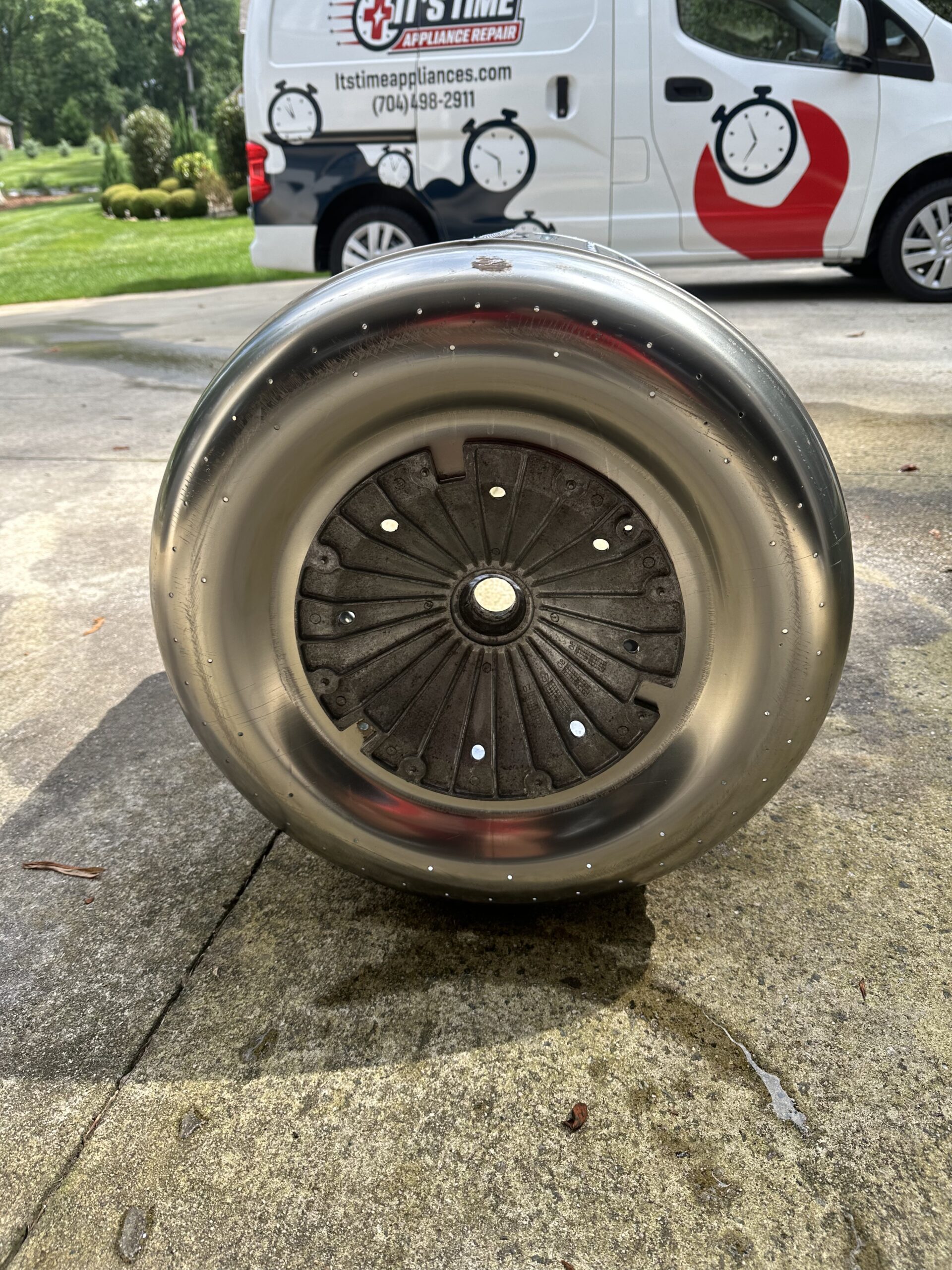 Shining sparkly washing machine drum professionally cleanned for proper machine running flowing efficiently.